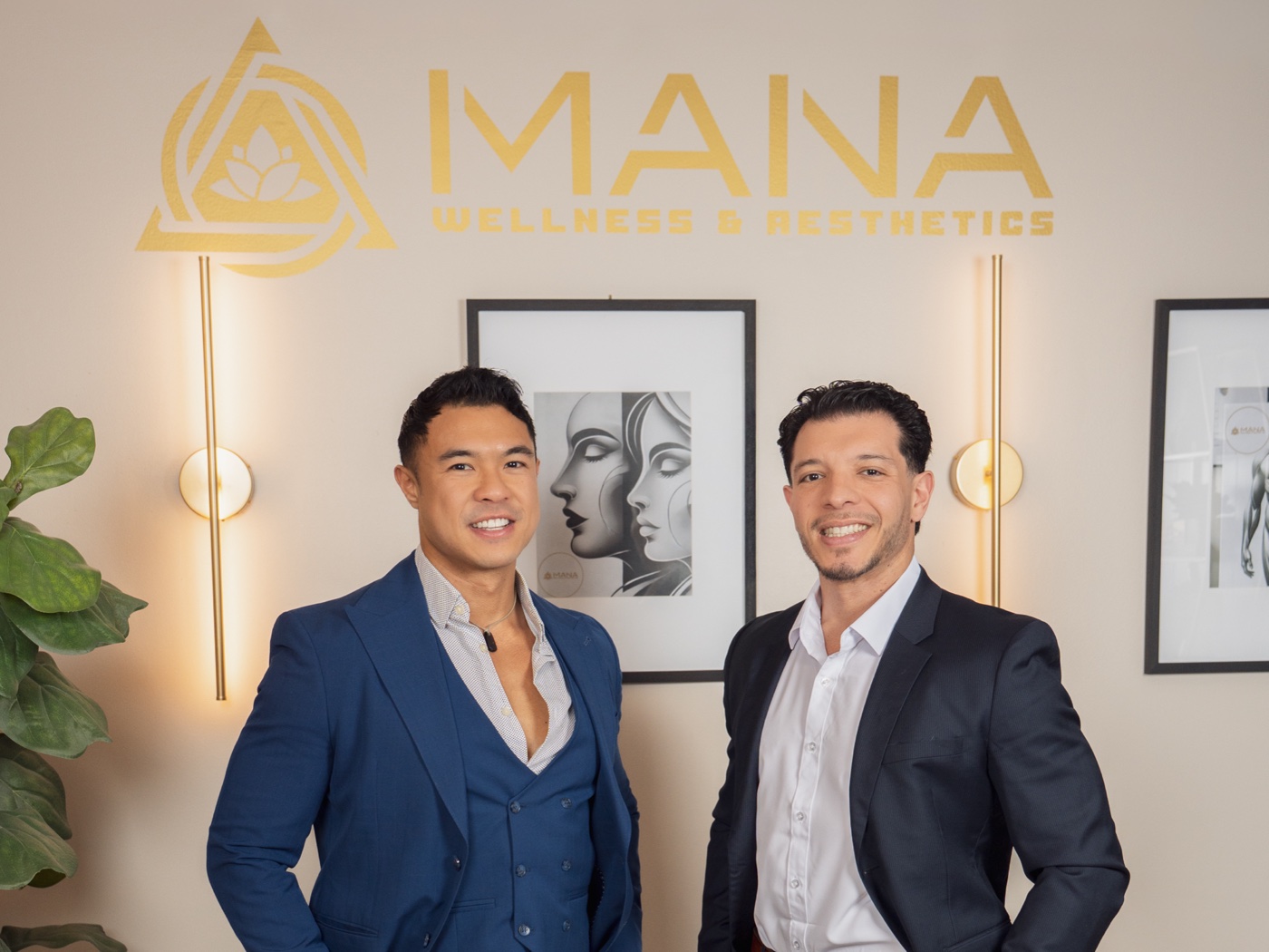 Mana Wellness & Aesthetics founders Marc Musni, left, and Oscar Munoz Jr., right, beneath the practice's wall sign in Denville